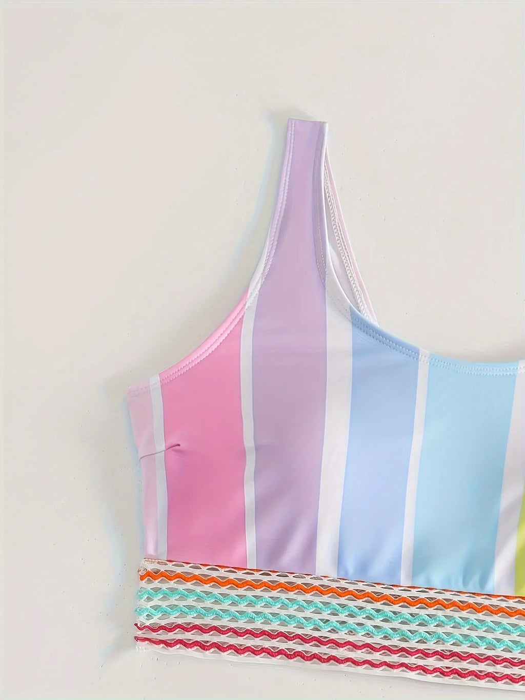 Women's striped two-piece bikini on a hanger, showing sporty briefs with spandex lining and matching top.