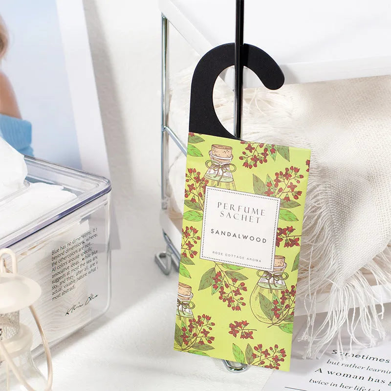 Pack of five household wardrobe sachets with lavender, rose, jasmine, sandalwood, vanilla, apricot blossom aromas on a shelf
