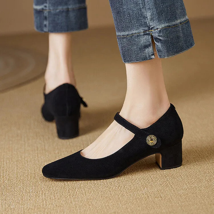 Women's black suede Mary Jane pumps with a chunky heel and square toe on a white background.