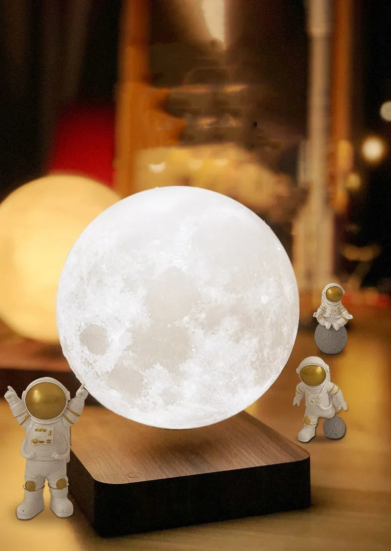 Maglev floating LED night light with planet design and three astronaut figures on display