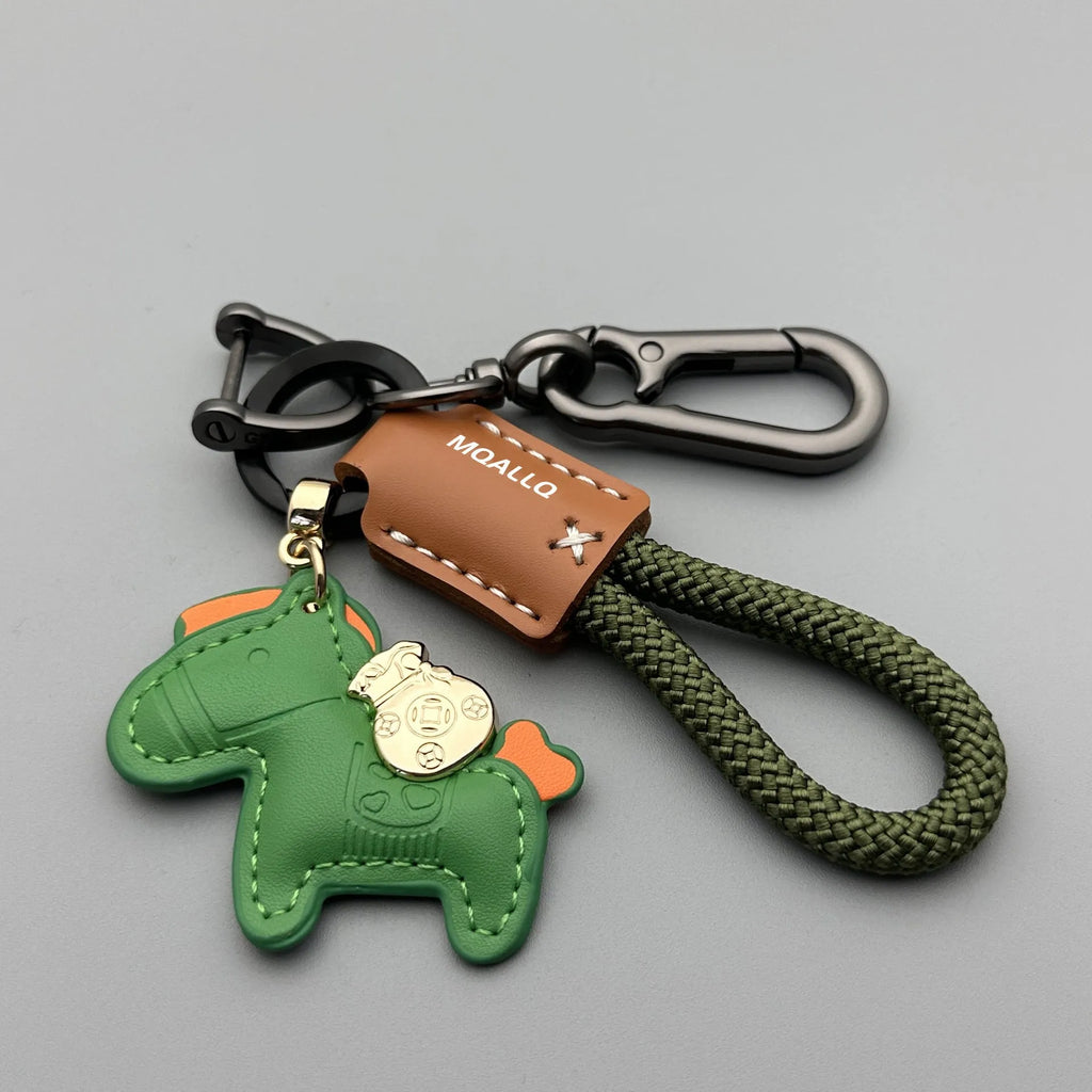Handmade brown cowhide leather key ring with a zinc alloy pendant charm on a green flannel rope.