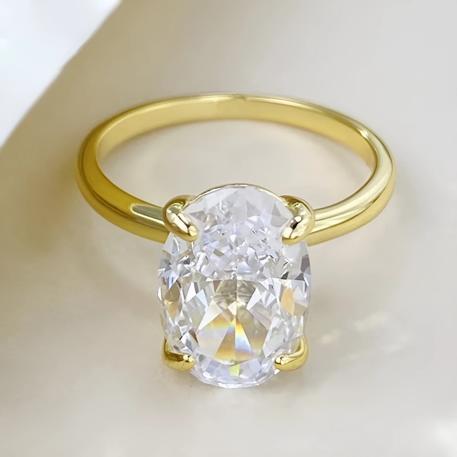 Oval gemstone ring for women in sterling silver with a four-claw setting, shown in gold and silver plating options.