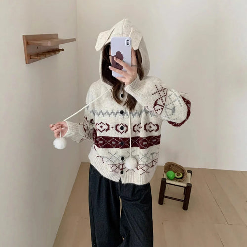 A beige, loose-fitting brocade knit sweater coat for plus size women with a geometric pattern.