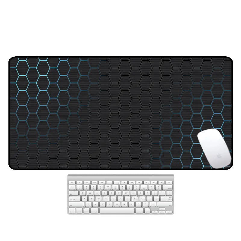 Large printed desk mouse pad with natural rubber non-slip base, shown on a wooden desk.