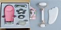 White jade facial roller and Gua Sha scraping board set on a neutral background.