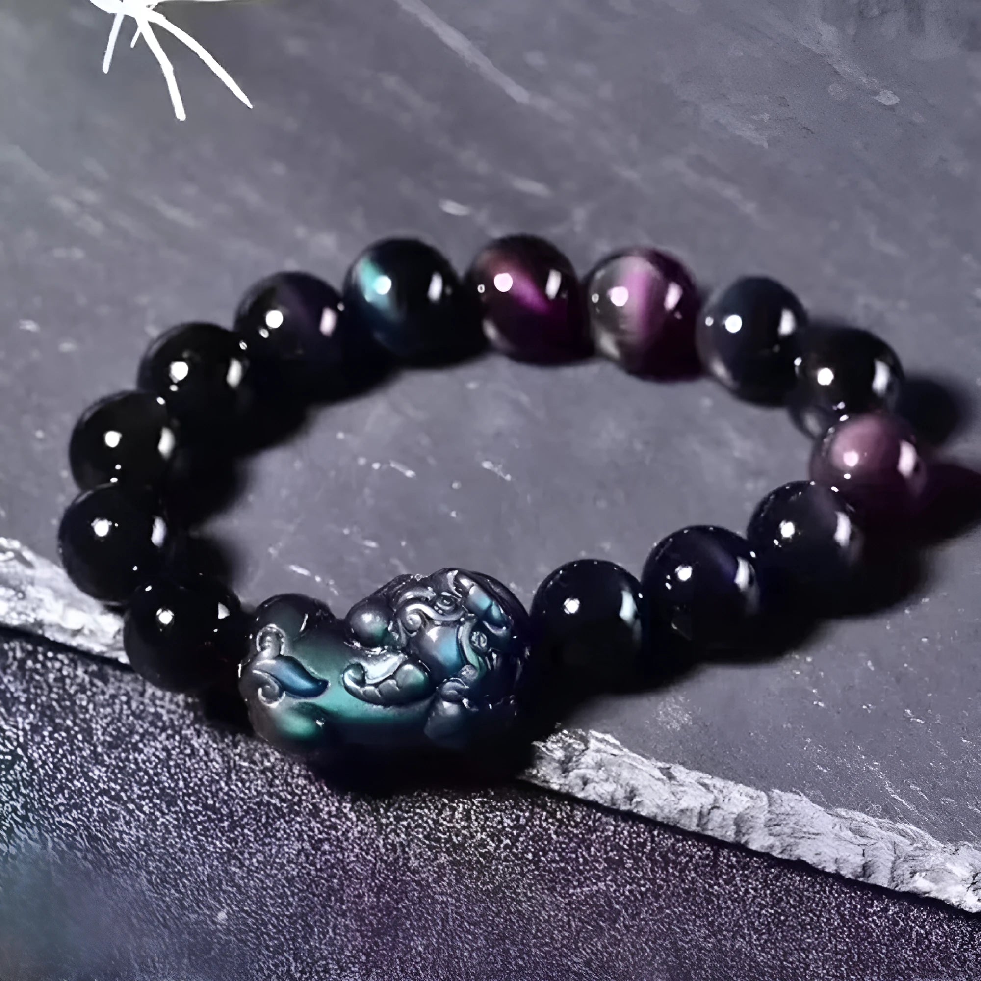Natural ice colour eye obsidian crystal bracelet with spherical beads on a string.