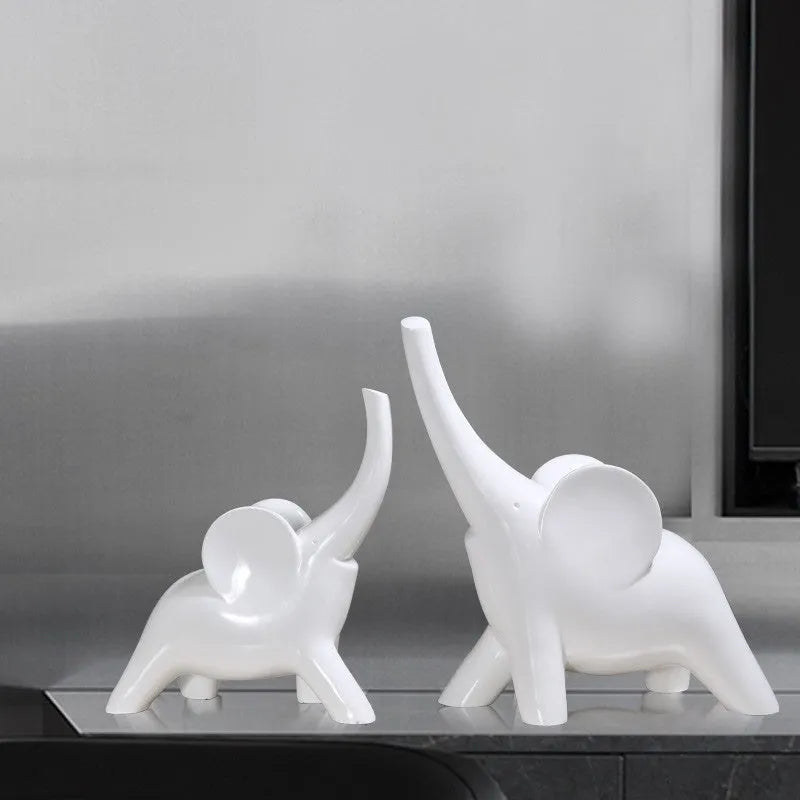 Modern minimalist elephant figurine ornament in rose gold or white resin on a plain background.