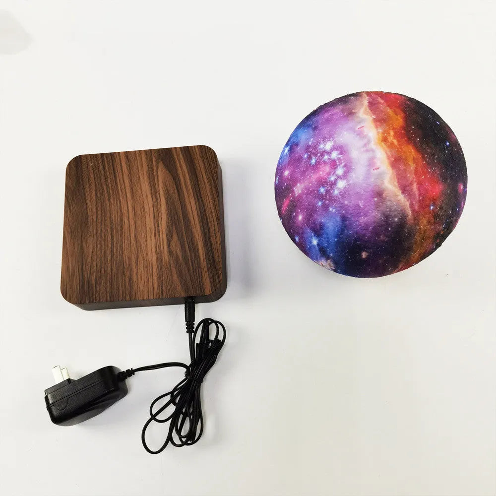 Walnut-colour base with a floating galaxy moon lamp levitating above it, showing starry sky details.