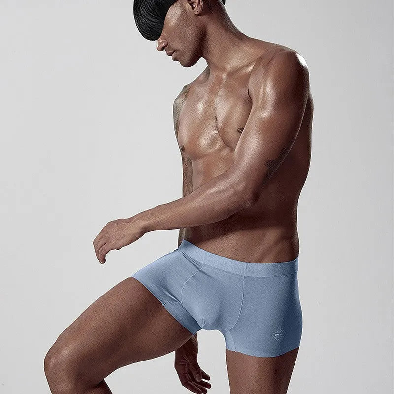 Men's seamless modal underwear in mid-waist fit, shown in green colour.