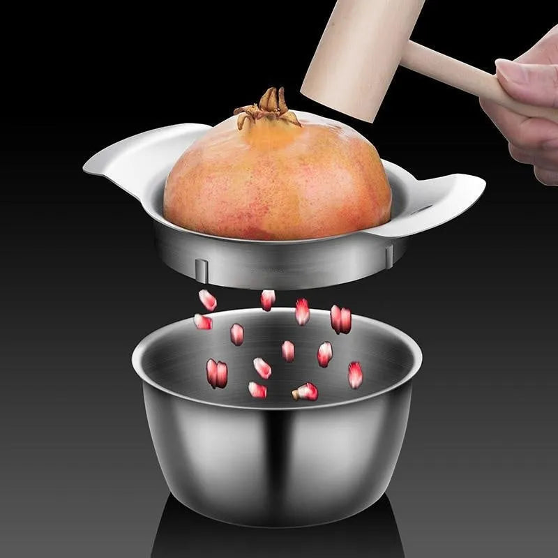 Stainless steel pomegranate fruit cutter tool with optional bowl and wooden hammer on a kitchen surface.