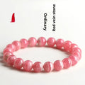 Women's geometric crystal bracelet with a longevity lock, shown in rhodochrosite colours.