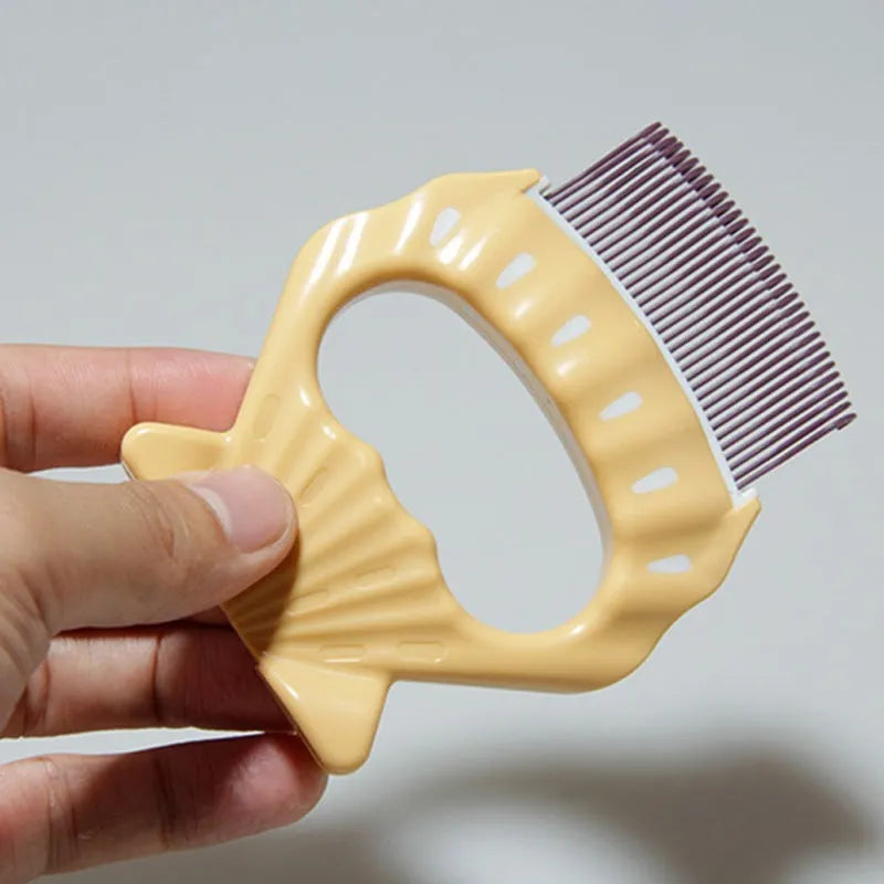 Green shell-shaped pet grooming comb with bent wire bristles and an anti-slip plastic handle.