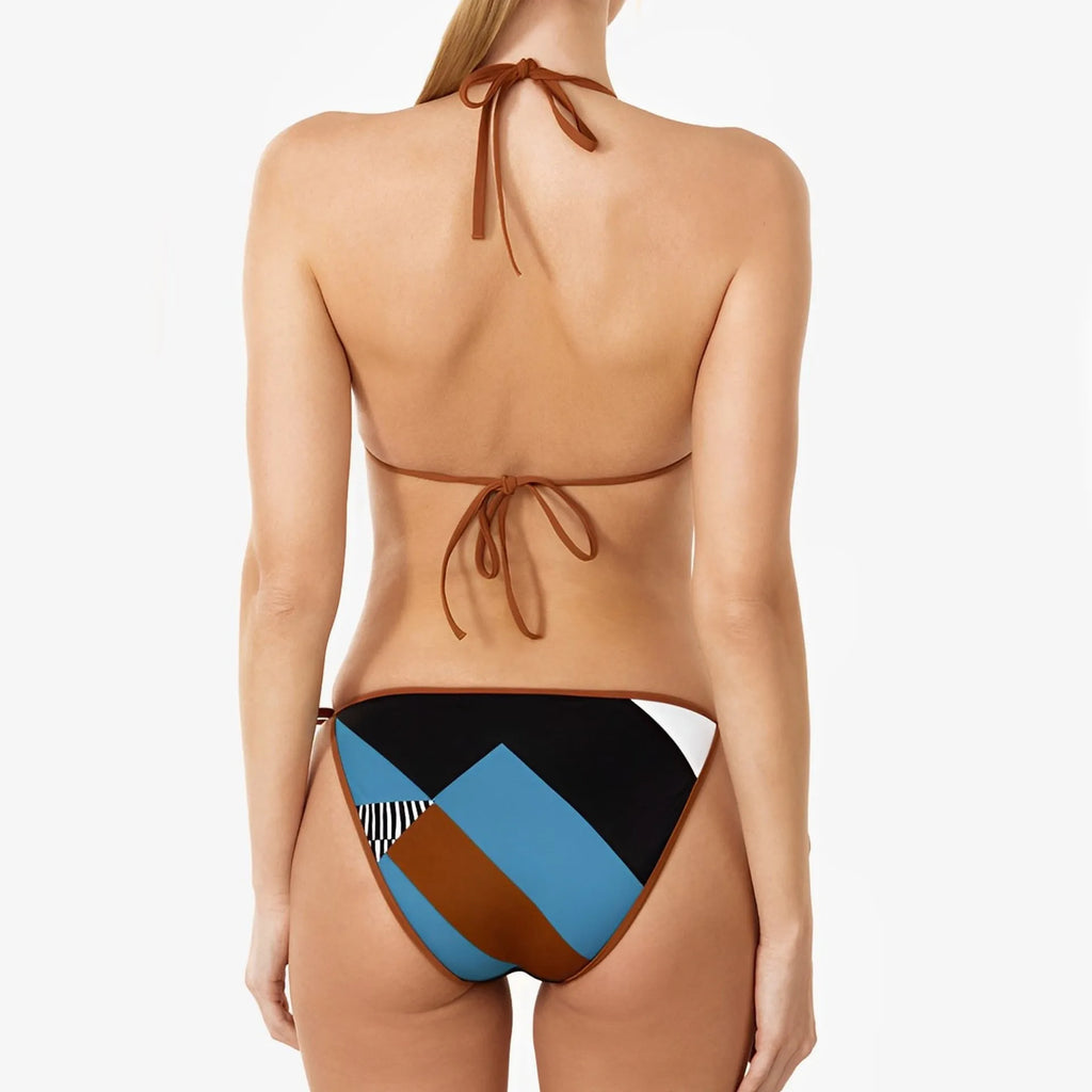 Women's skinny print bikini with backless top and solid colour, laid flat.