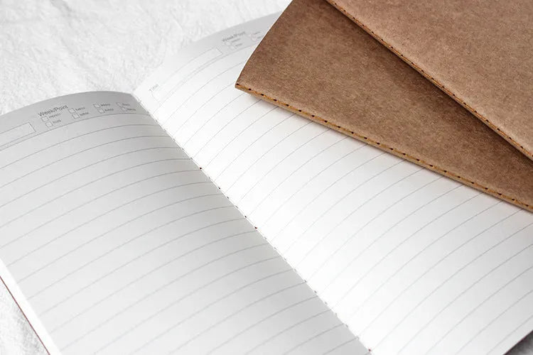 Diary refill inner core showing saddle stitch binding and 11x21cm dimensions
