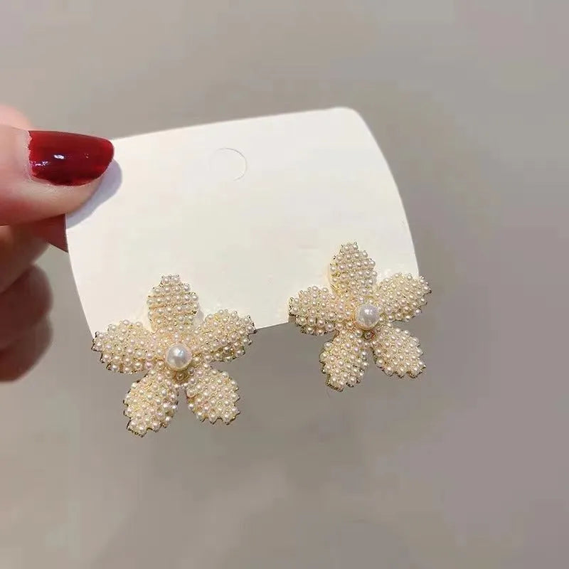 Gold pineapple and starfish pearl Korean style drop earrings with alloy electroplating and inlaid gems.