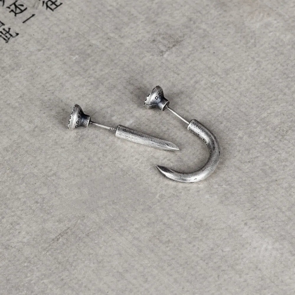 S925 sterling silver nail stud earrings in straight and curved punk designs on a plain background.