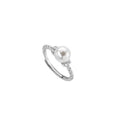Antique-style twisted copper ring with a central white pearl, shown on a finger, adjustable band visible.