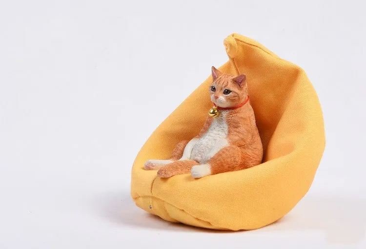 Lazy cat car ornament figure on fabric sofa, 7.5cm high resin model decoration.