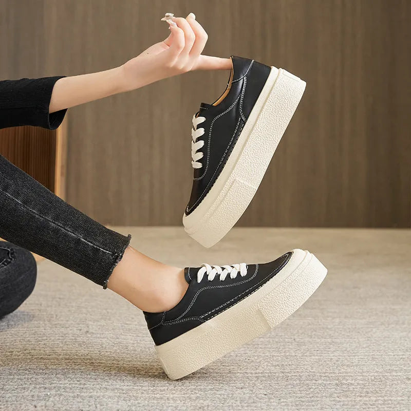Women's black platform trainers with embossed leather upper and rubber sole