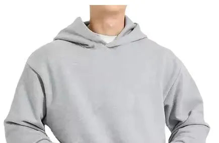 A man's solid-colour fleece-lined cotton hoodie with a wool interior, shown in a casual setting.