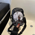 Black mini square crossbody bag with orange Halloween graffiti print of cartoon pumpkin, ghost, and bat.