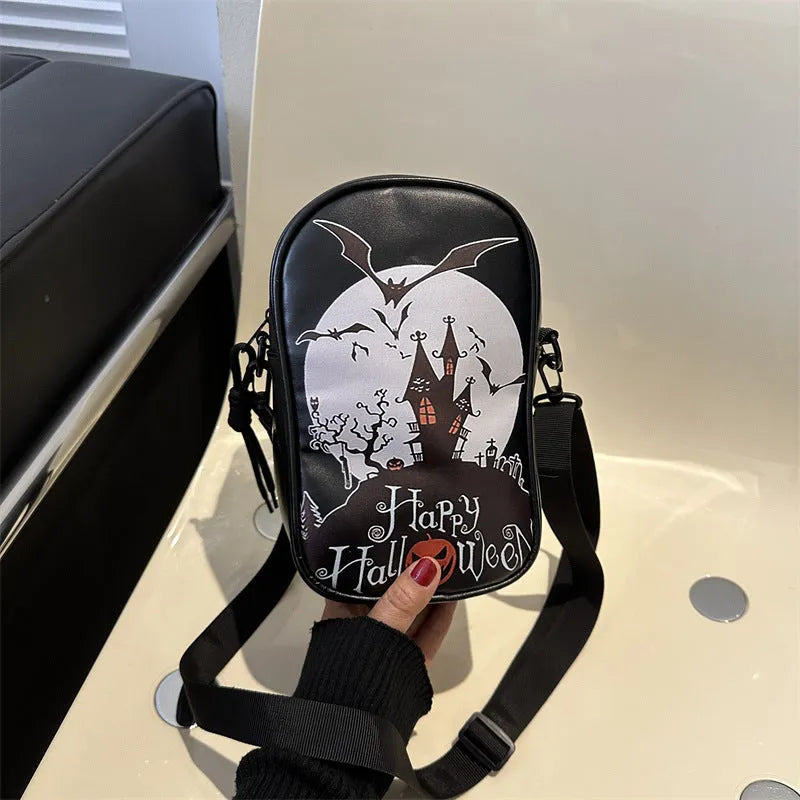 Black mini square crossbody bag with orange Halloween graffiti print of cartoon pumpkin, ghost, and bat.