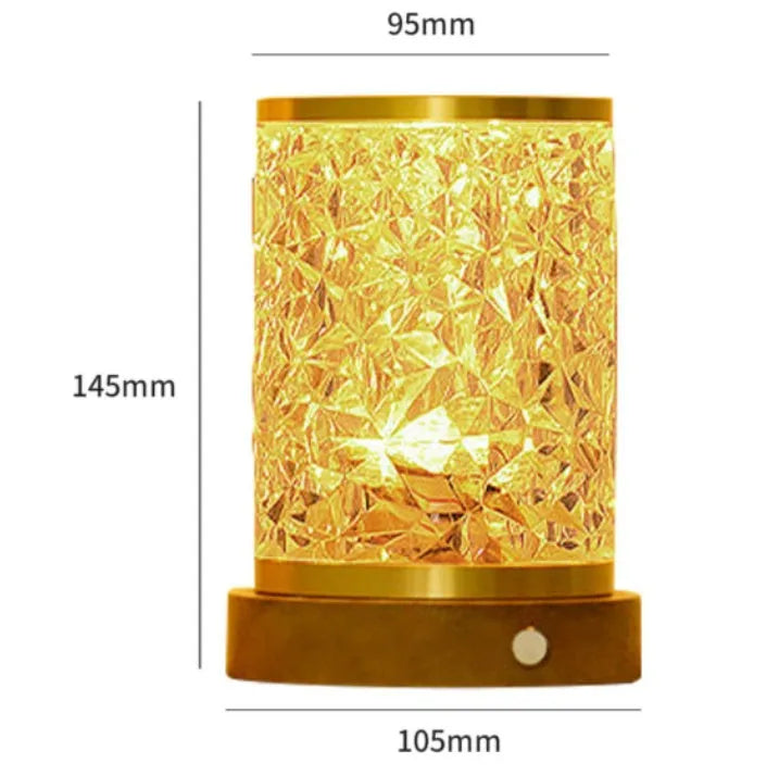 Small rotating water ripple night light on a wooden base with a USB cable.