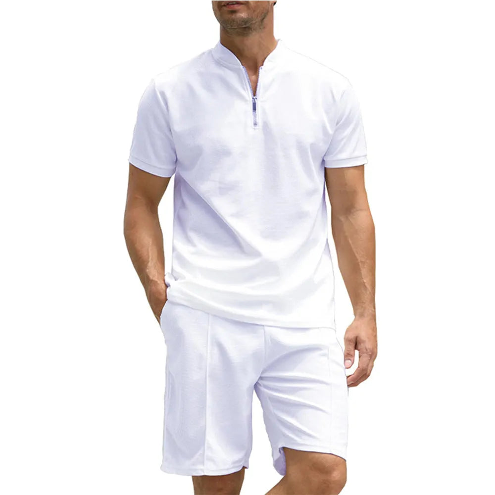 Men's solid colour polo shirt and trouser two-piece set in textured fabric.