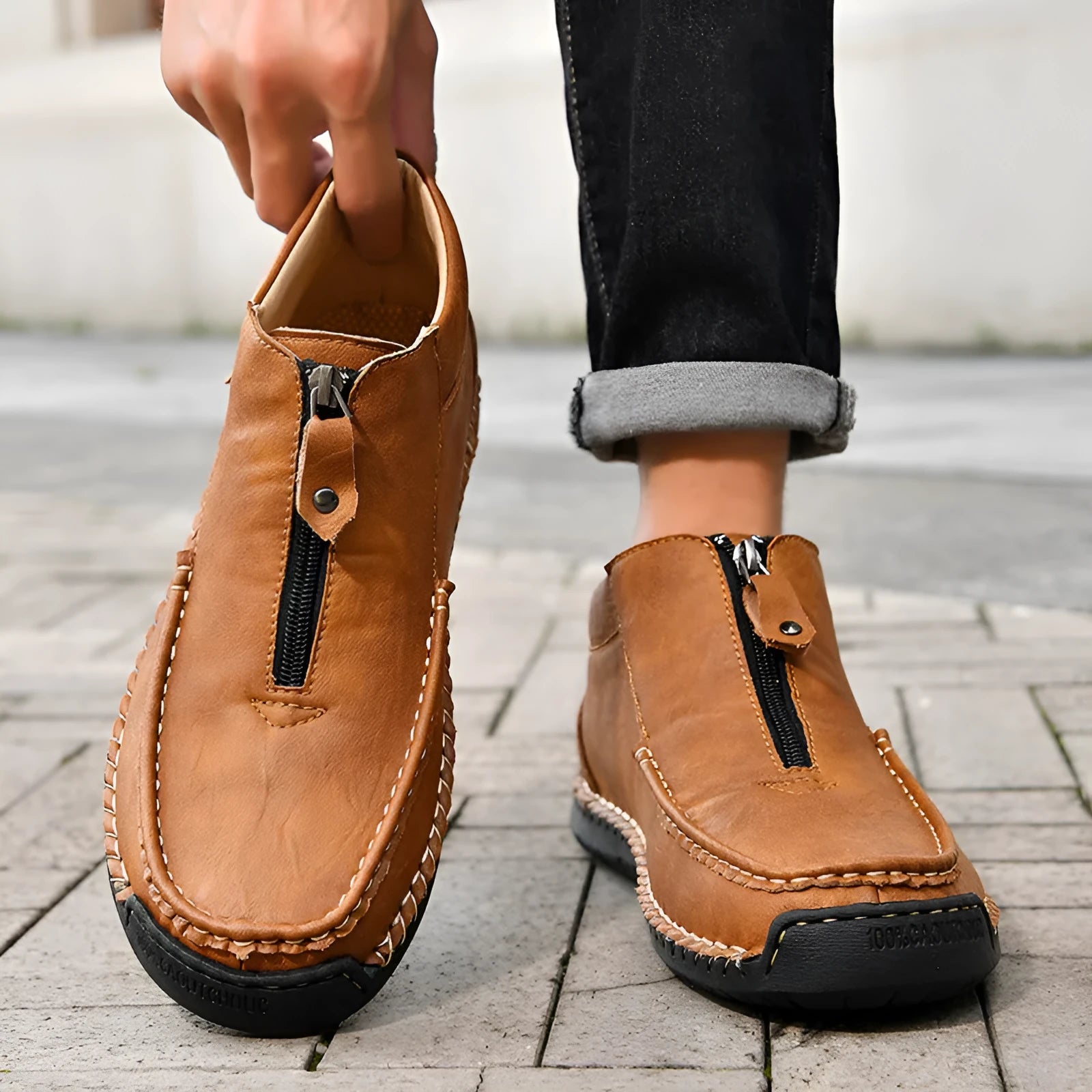 Men's black slip-on leather loafers with round toe and rubber sole, displayed on a white background.