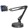 Black universal phone stand with long adjustable metal arm and heavy round base on a desk