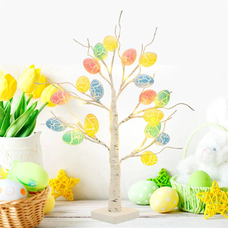 White plastic birch tree Easter decoration with warm white LED lights and hanging coloured eggs on adjustable branches.