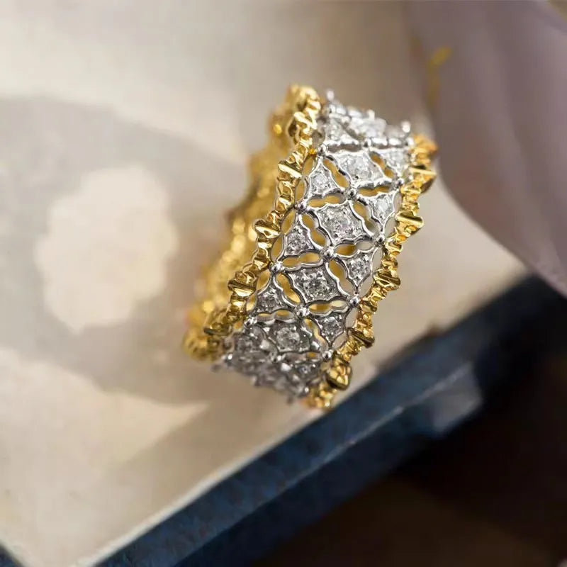 A geometric two-tone gold zircon ring on a hand, showing its round design and copper construction.