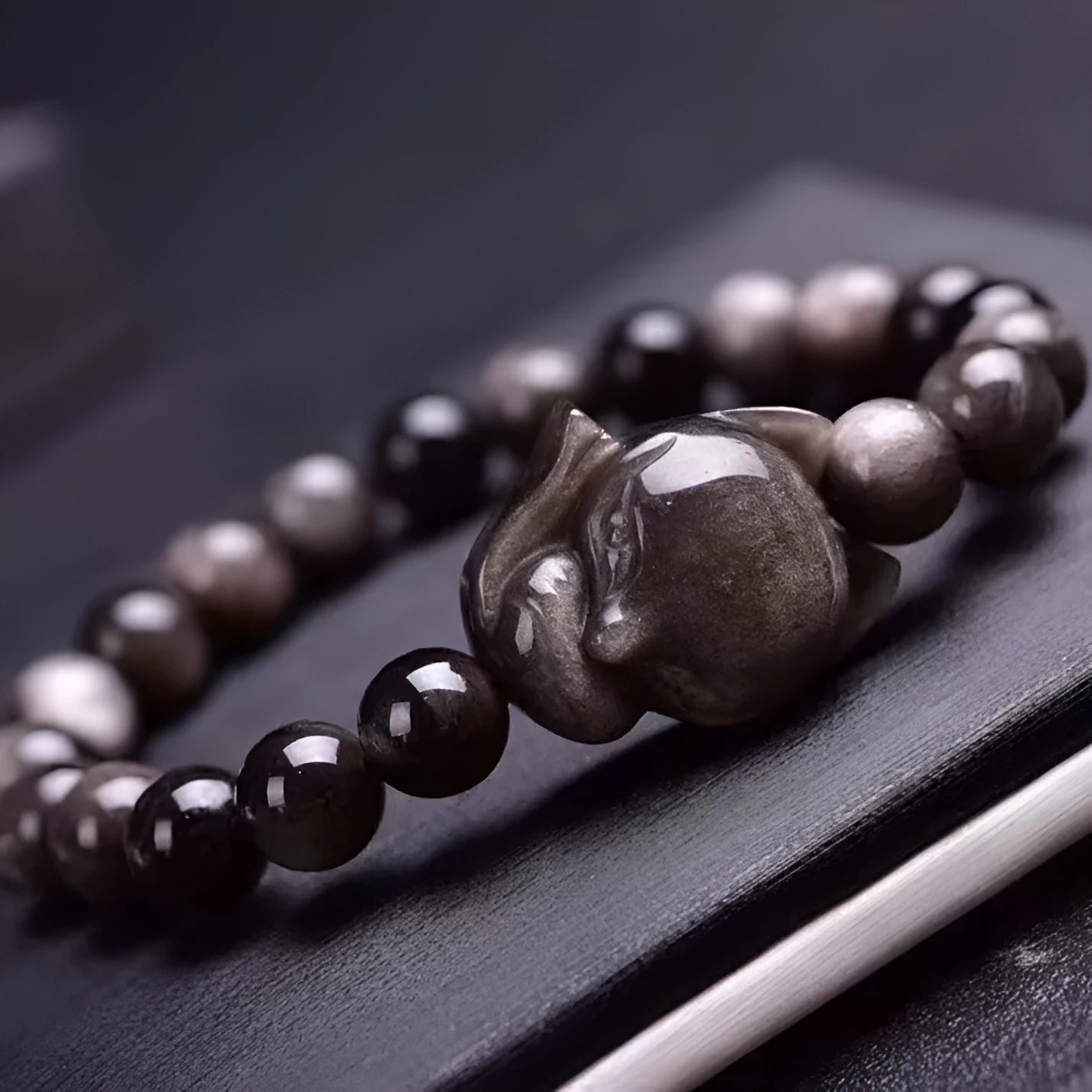 Obsidian fox single ring bracelet with 8mm black stone bead and silver charm on elastic cord.
