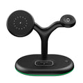 Black magnetic wireless charging stand holding a phone upright on a desk.