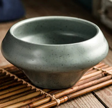 Tall porcelain ceramic Japanese soup bowl with underglaze vintage pattern on wooden table.