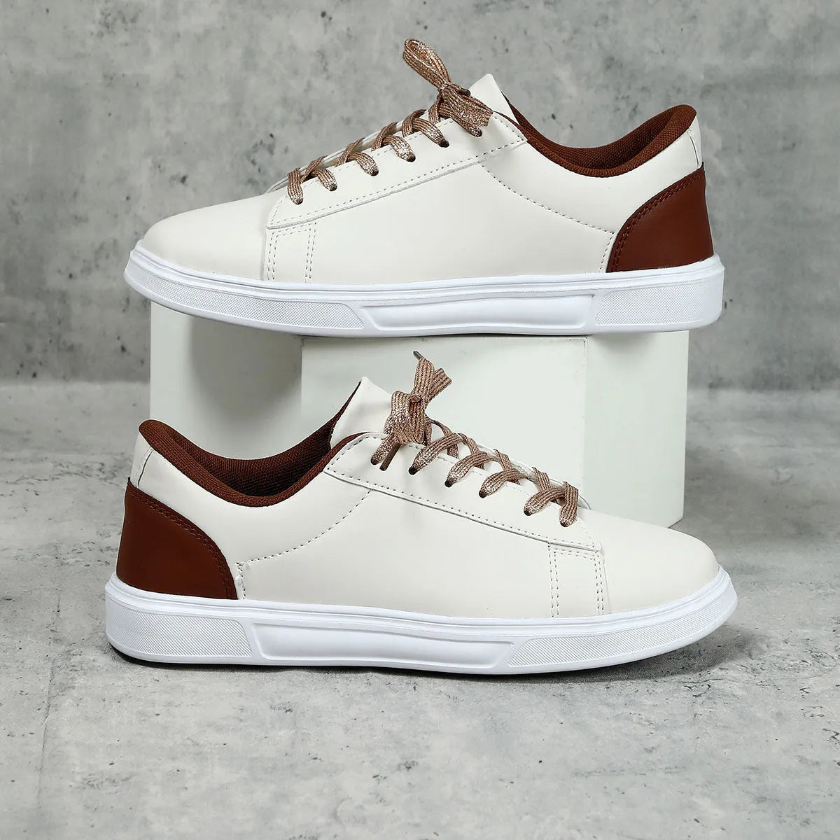 Platform skateboard casual sneaker in beige brown with low top, round toe, and a cross strap detail.