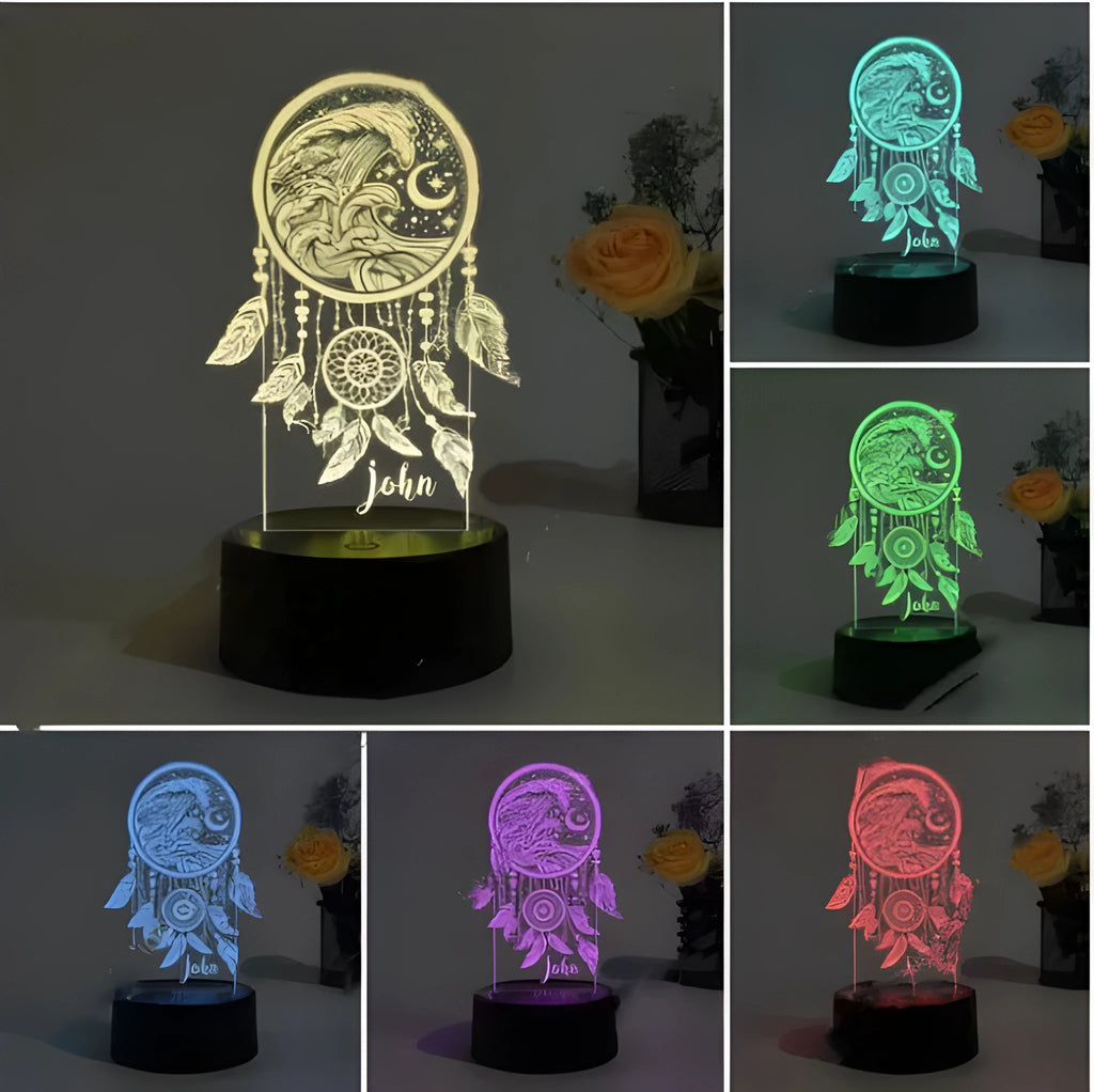 Black-based acrylic dream catcher table lamp with colourful LED lights on a wooden surface.