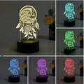 Black-based acrylic dream catcher table lamp with colourful LED lights on a wooden surface.
