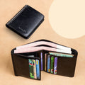 Men's black full-grain leather bifold wallet open, showing card slots, zip coin pocket, and banknote section.