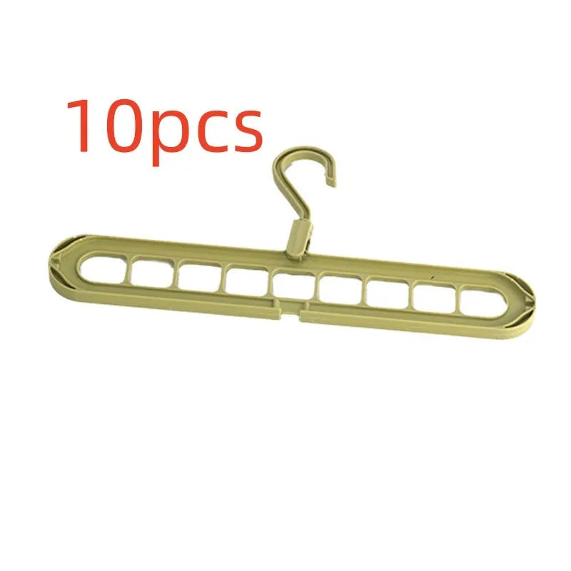 Green nine-hole plastic folding hanger for trousers and skirts showing multiple garment hanging points
