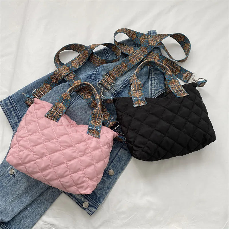 A soft Oxford cloth shoulder messenger bag in a horizontal square shape with embroidery detail.