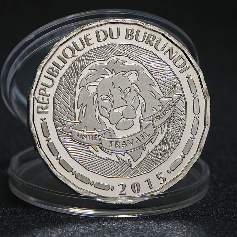 Set of eight silver plated commemorative coins with tropical fish and marine animal designs, 40mm diameter, in acrylic box