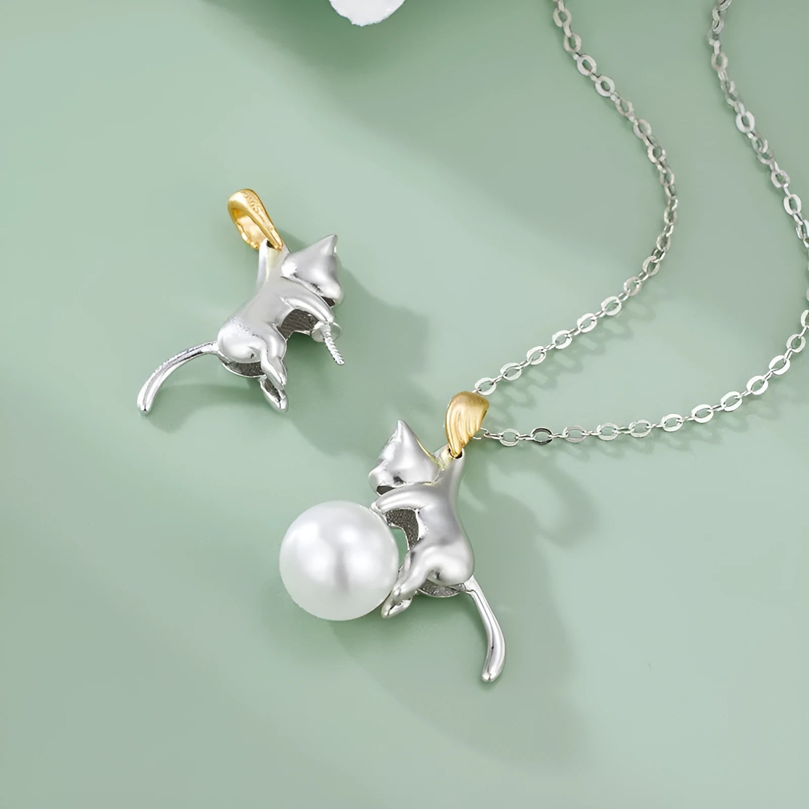 Sterling silver clavicle-length necklace with a cat charm pendant.
