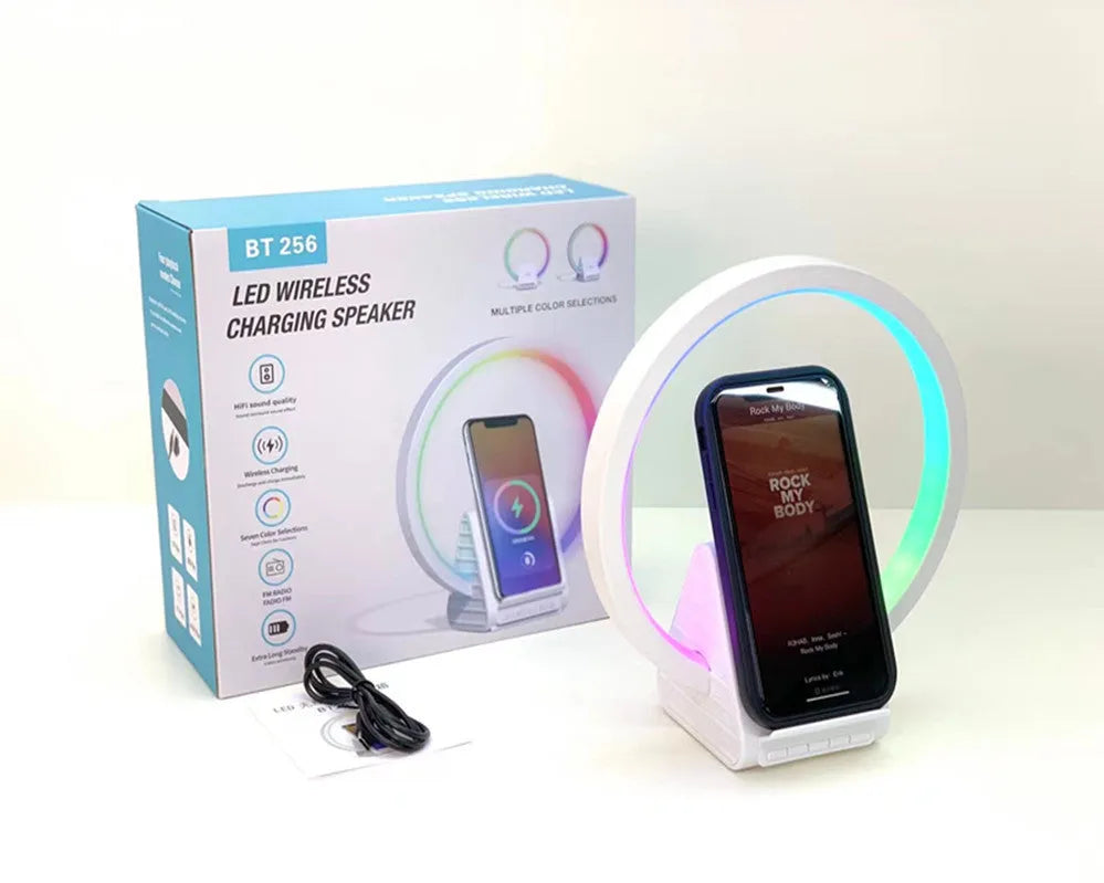 White smart Bluetooth speaker with wireless charging surface and ambient lighting