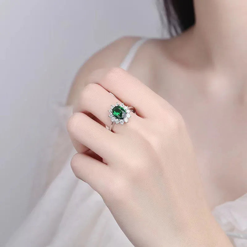 Copper floral women's ring with inlaid zirconia stone in green, blue, or red colour on a white background.