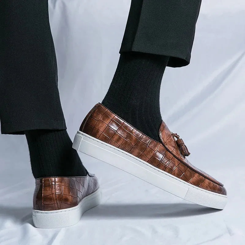 Men's brown tassel sneakers with round toe and rubber sole on a white background.