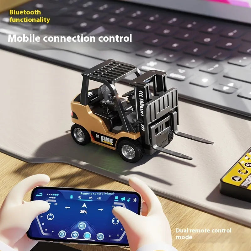 1:64 scale silver alloy remote control forklift model with accessories on a tabletop obstacle course.