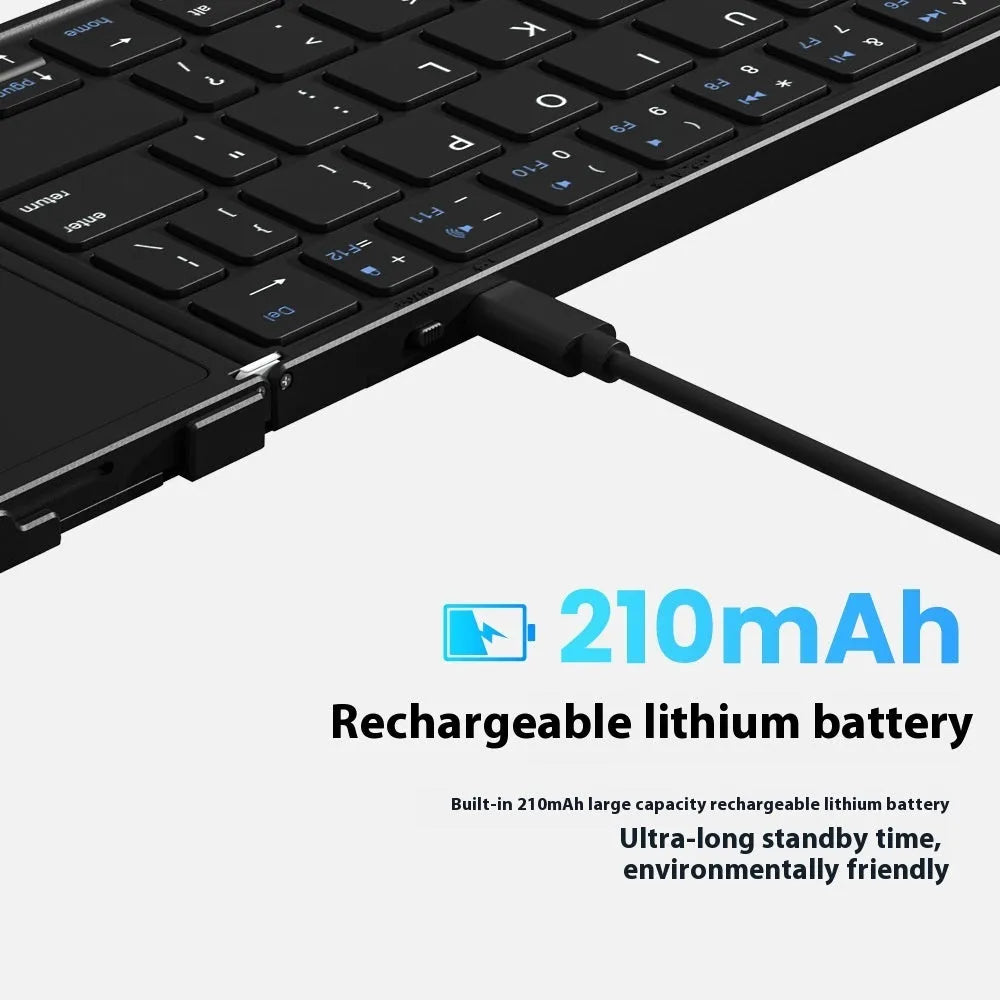 Black folding Bluetooth keyboard showing compact folded size beside mobile phone