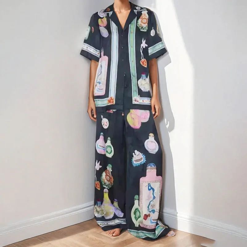 Black women's co-ord set with cartoon animation print, featuring a cardigan and trousers.