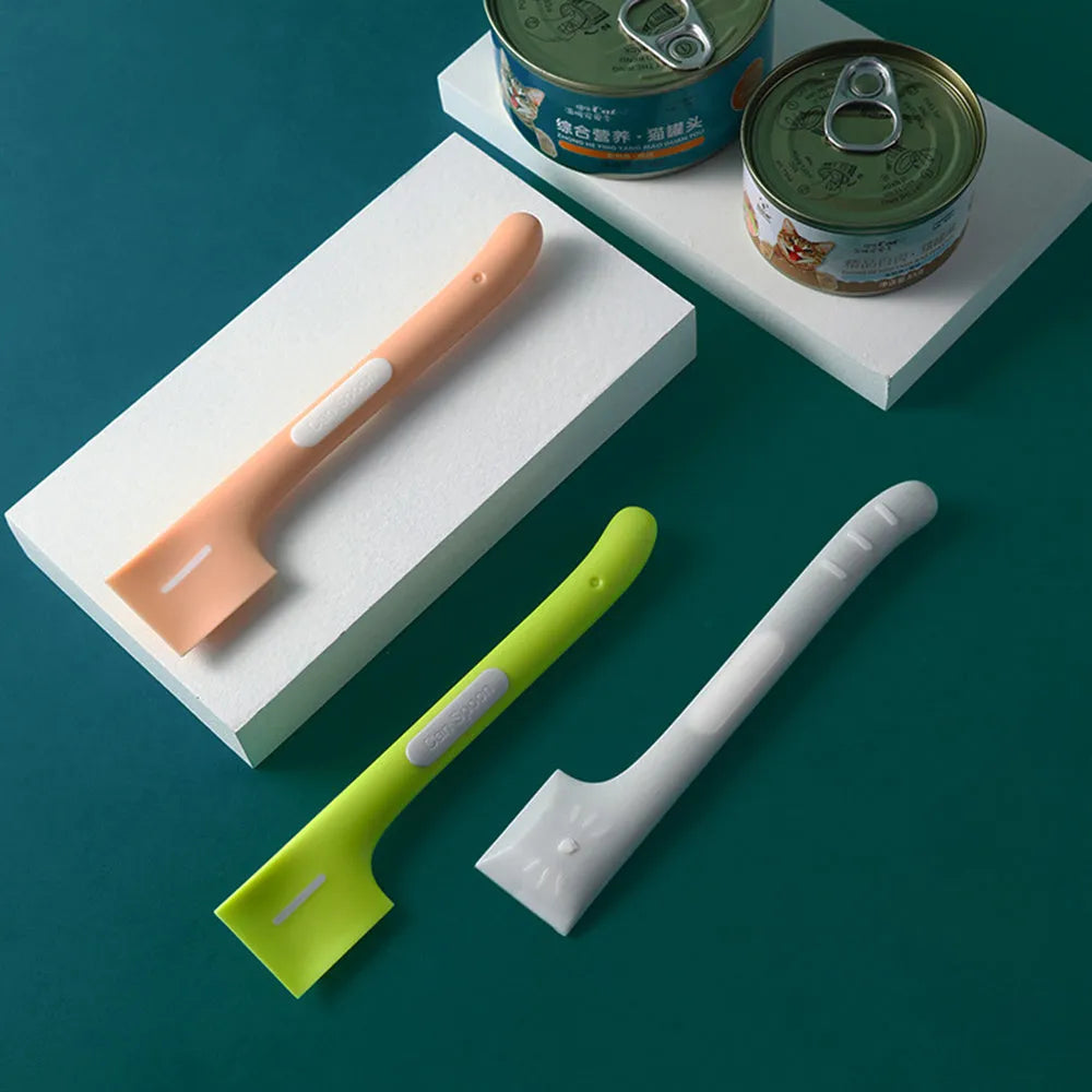 Green long-handled TPR spoon for scooping wet pet food from a tin.